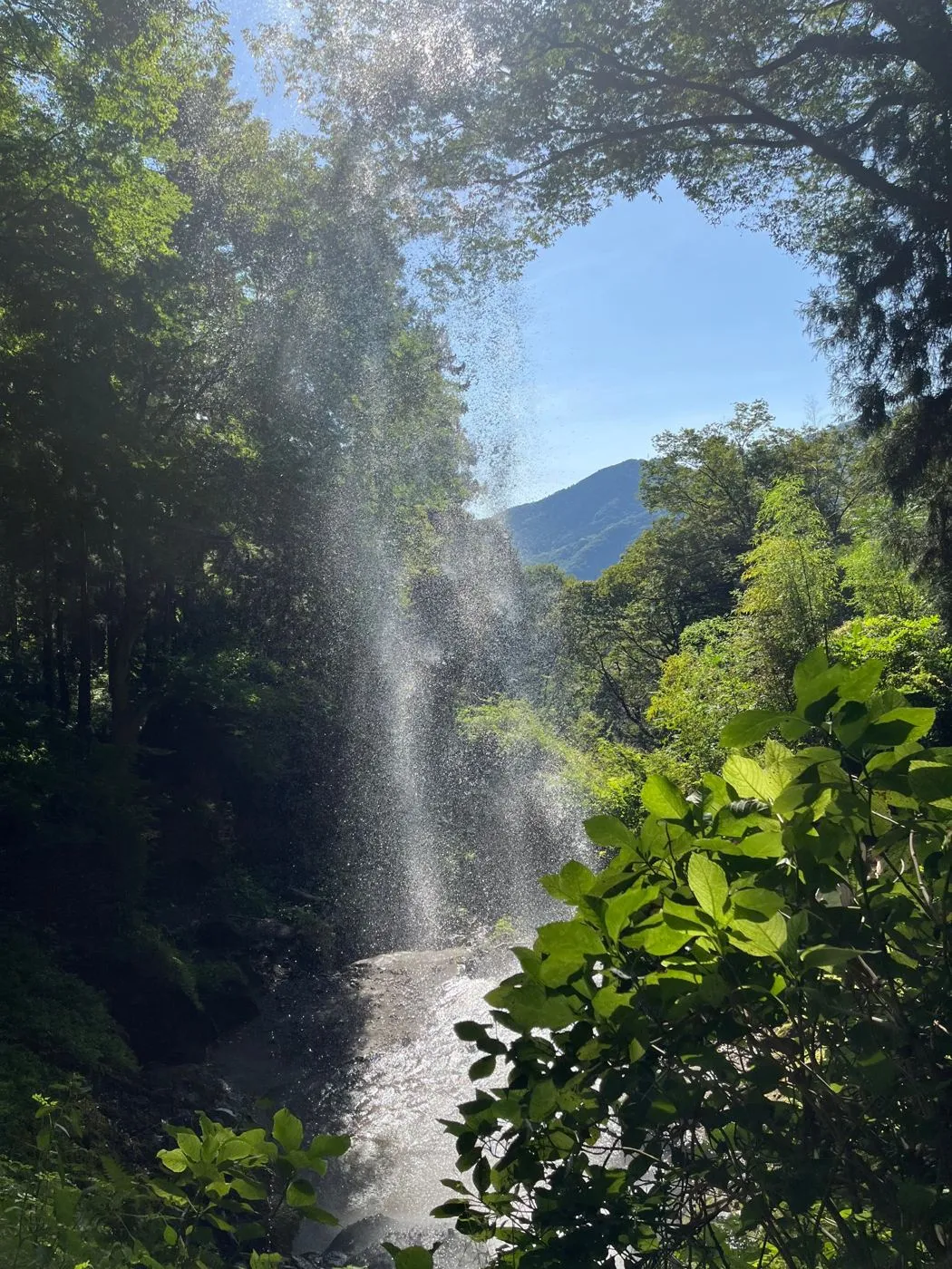 Looking out at the sky from behind Tanashita Fudō Falls